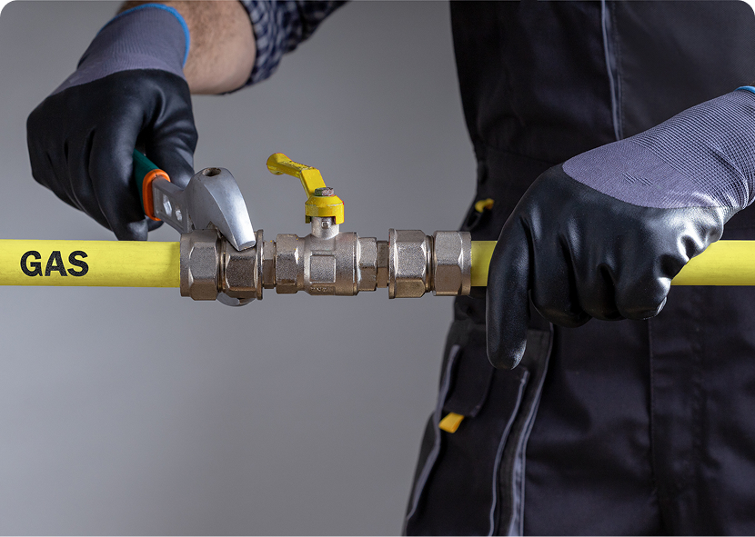 Worker adjusting yellow gas pipe