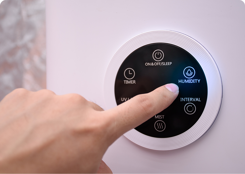 Finger pressing humidifier control button