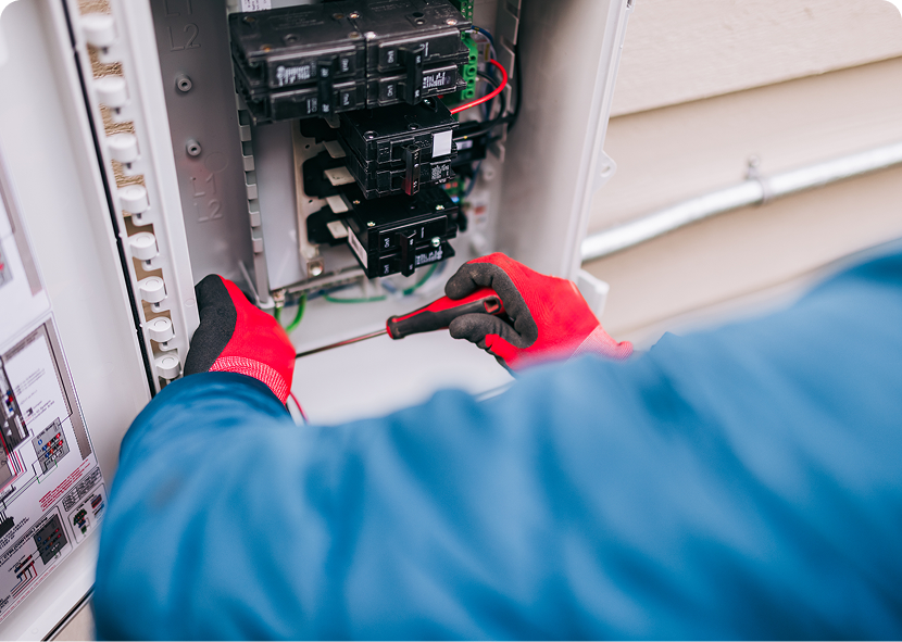 Technician repairing electrical panel outdoors