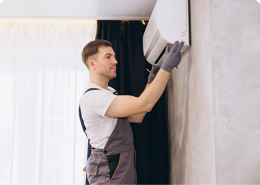 Technician installing air conditioning unit