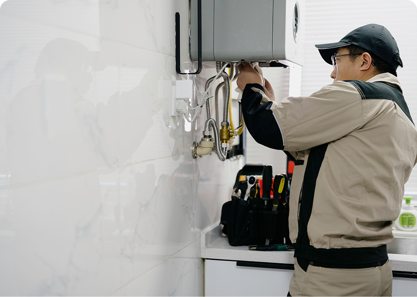 Plumber fixing kitchen water heater